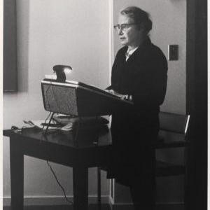 Thelma G. Alper giving a lecture from a podium at Radcliffe College